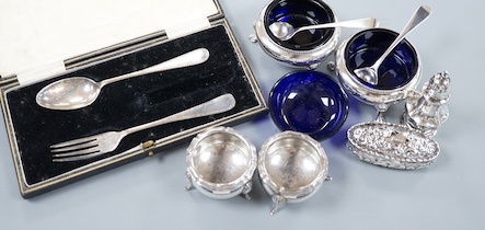 A pair of Victorian silver bun salts with blue glass liners and spoons, a spare liner, a later pair of small silver salts, a silver pepperette, a small silver box and a silver christening pair in box for three.